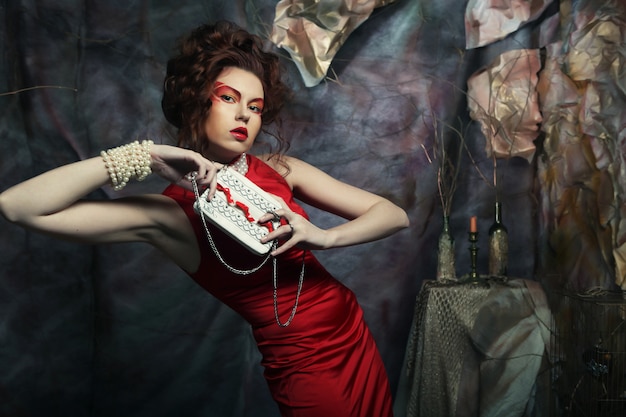 Woman in red dress with white handbag