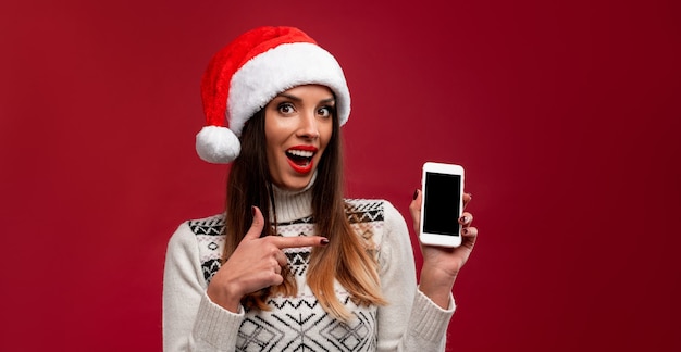 Woman in red Santa hat on red