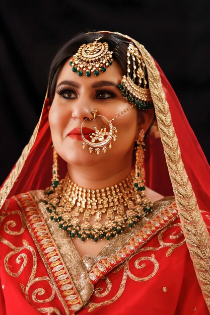 A woman in a red sari with gold jewelry