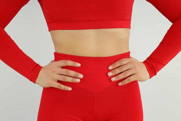 Woman in red sport outfit on light background