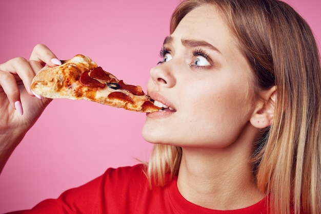 Woman in red tshirt snack fast food pink background