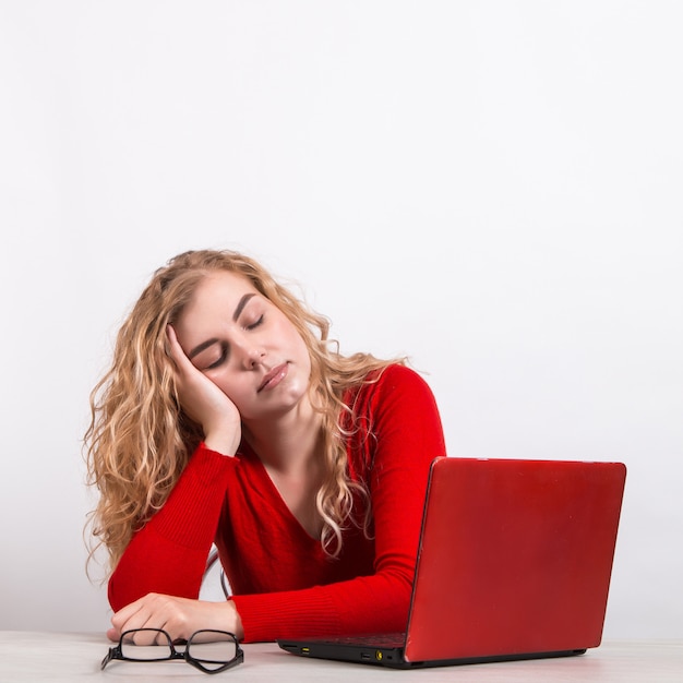 woman in red, working remotely at the computer on white.