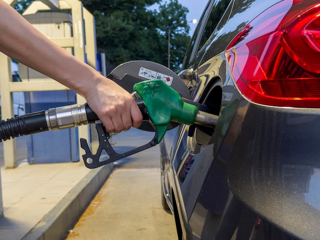 Woman refilling car at petrol station