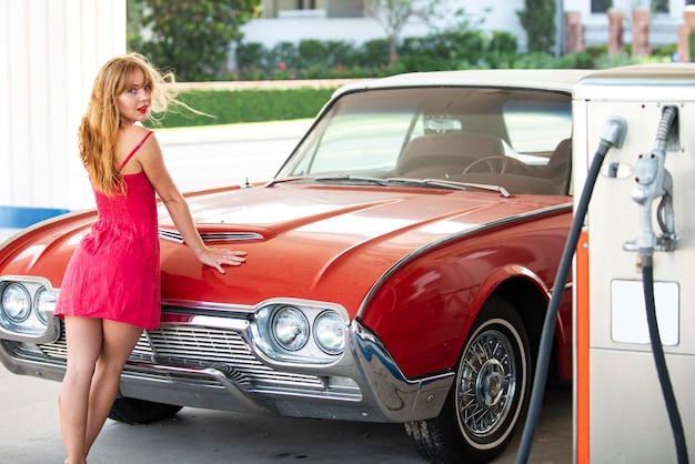 Woman refuel the car Gas station Girl against red retro automobile