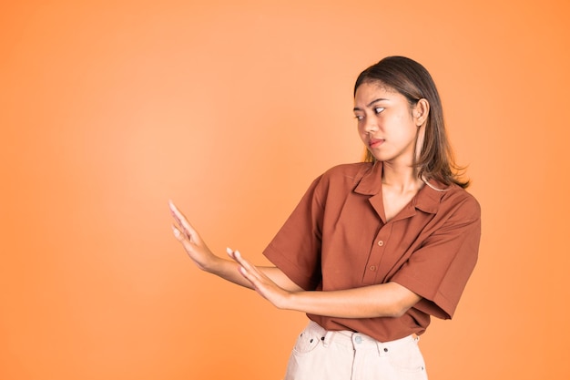 Woman refusing with both palms gesture over isolated background