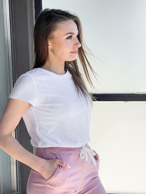 A woman relaxes on the balcony against the background of the city