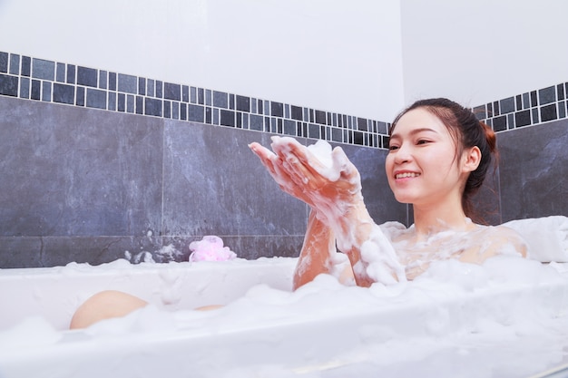 woman relaxing in the bathtub in the bathroom