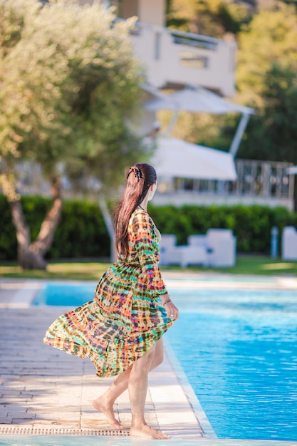 Woman relaxing by the pool in a luxury hotel