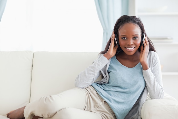 Woman relaxing on couch with headphones on