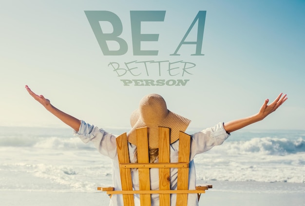 Woman relaxing in deck chair by the sea against be a better person