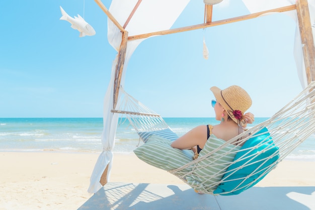 Donna che si distende in amaca sulla spiaggia