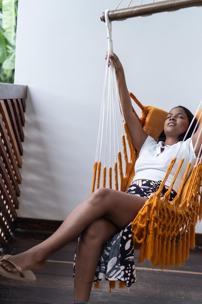 Photo woman relaxing in a hammock at home