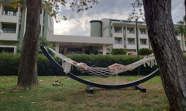 Woman relaxing in a hammock on an overcast day