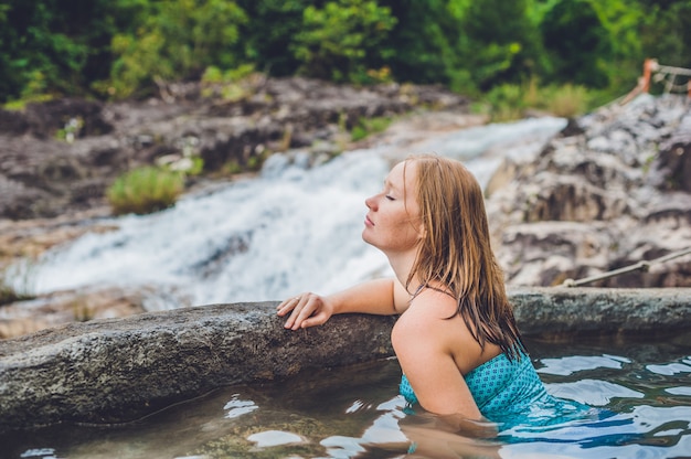 Woman relaxing in hot spring pool