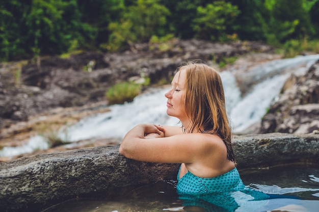 Woman relaxing in hot spring pool