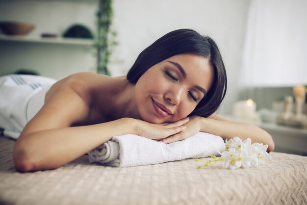 Woman relaxing during a massage in a spa center