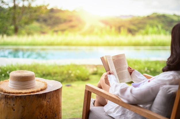 写真 秋の公園で本を読んでリラックスする女性