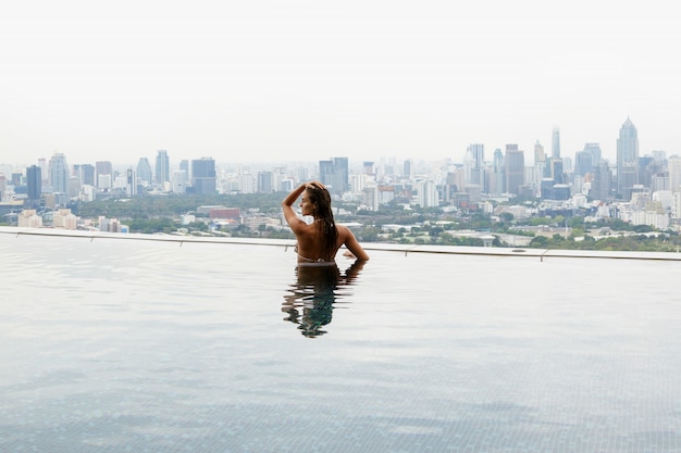 Woman relaxing on a rooftop pool