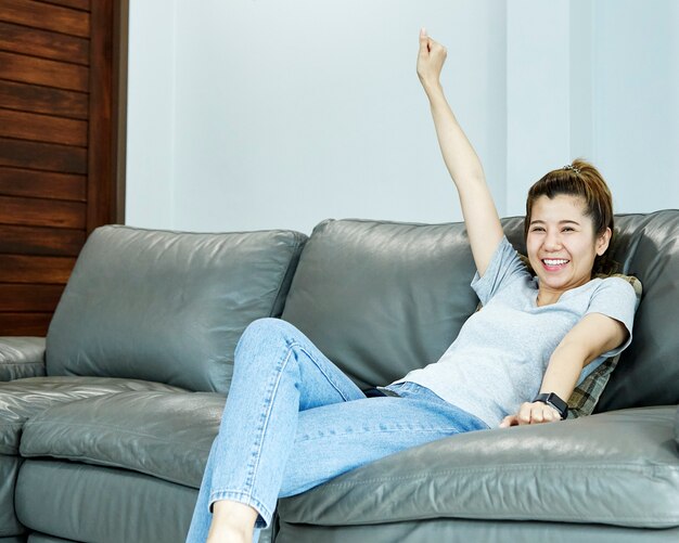 Woman relaxing on sofa at home in the living room