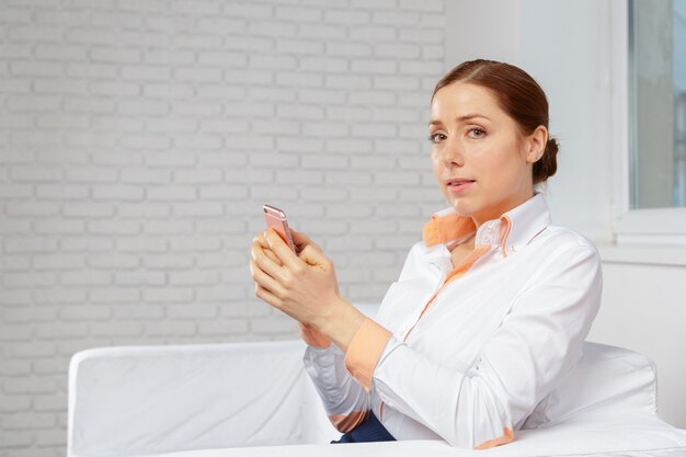 Woman relaxing in sofa talking on mobilephone