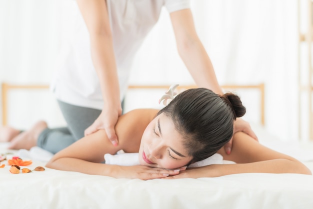 Woman relaxing while getting massage in spa