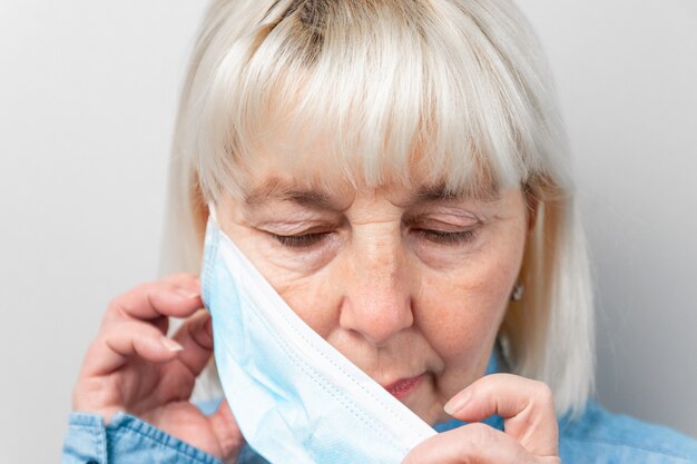 Woman removes medical mask