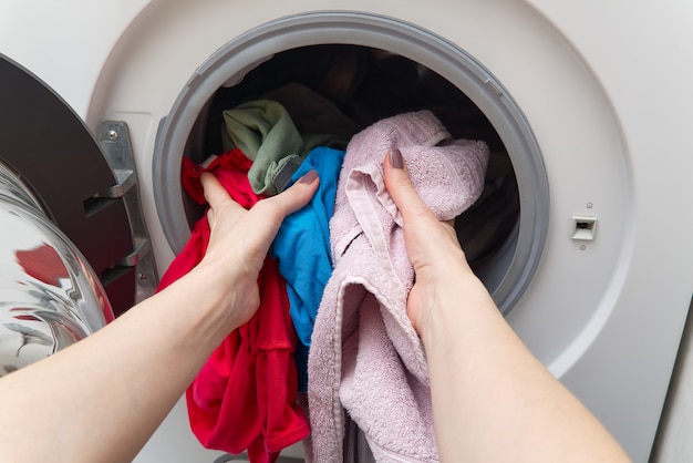 Woman removing laundry from the washing machine