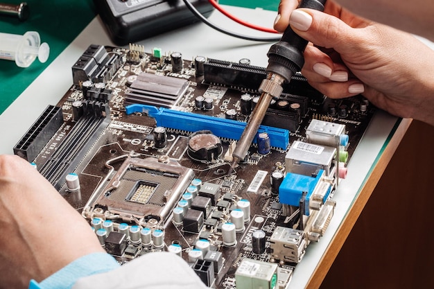 Woman repairing computer hardware in service center Repairing and fixing service in lab Electronics repair service concept