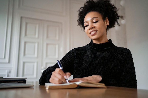 Photo woman report to book documents at home