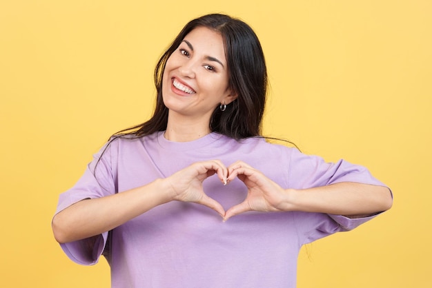 Woman representing a heart in the shape of fingers