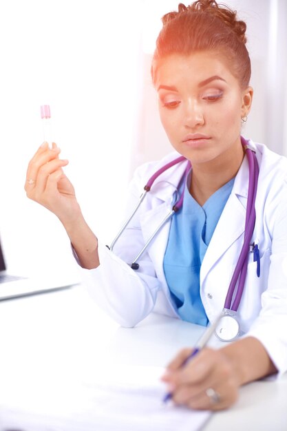 Woman researcher is surrounded by medical vials and flasks isolated on white background