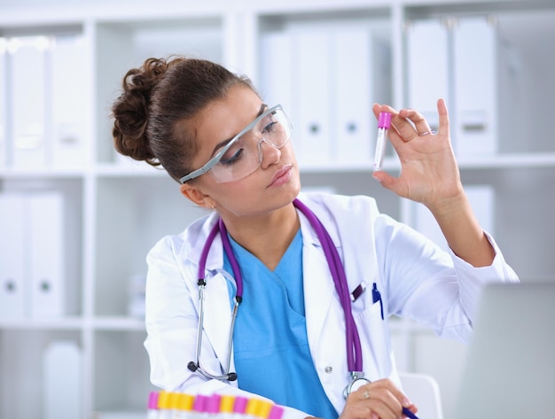 Woman researcher is surrounded by medical vials and flasks, isolated on white background