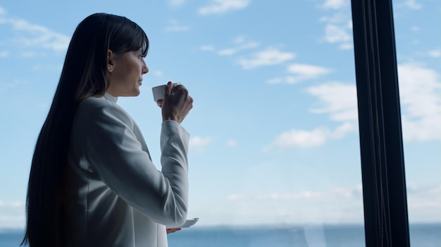 Woman rest coffee at ocean view closeup Businesswoman drinking near window