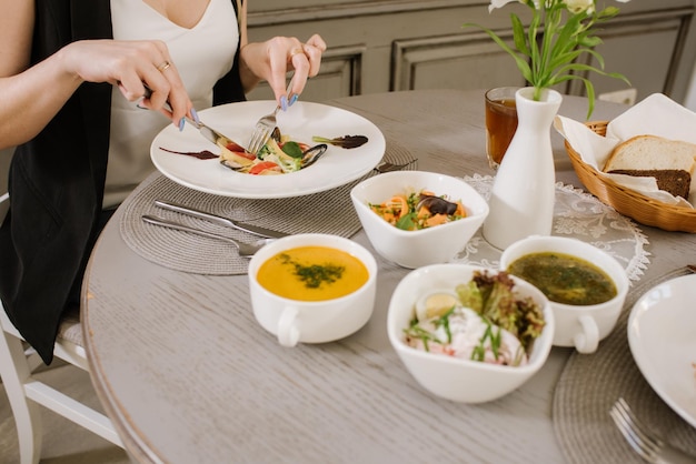 Woman at the restaurant eating her business lunch, close up