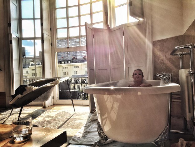 Photo woman resting in bathtub at home