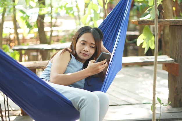 Woman resting in a hammock at a coffee shop