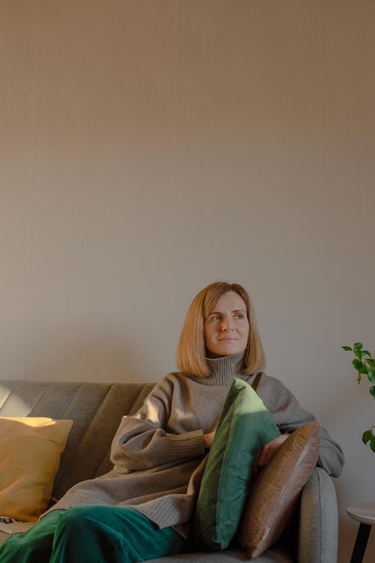 Woman resting on sofa at home