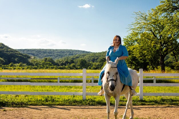 The woman restores her mental health by riding a horse