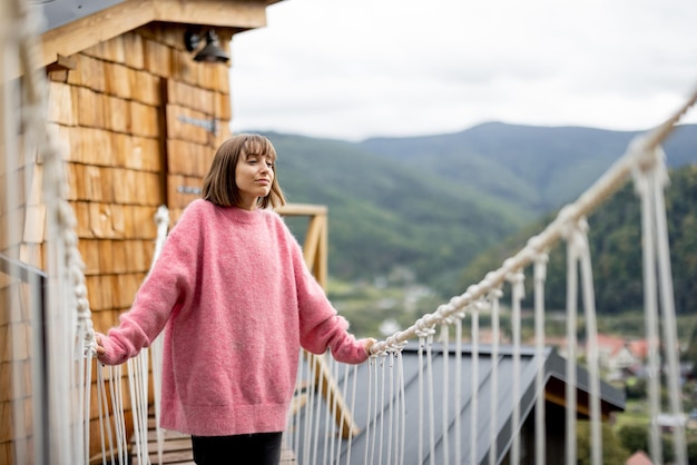 Woman rests at house in mountains