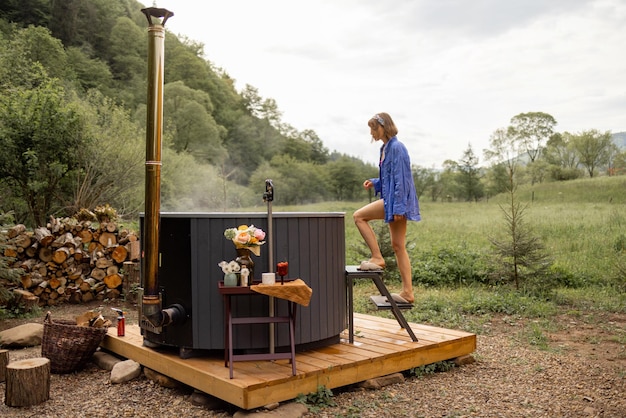 Woman rests in house with hot tub in the mountains