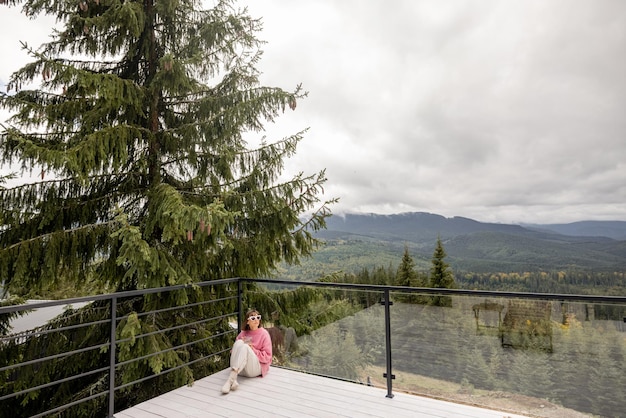 Woman rests on terrace in mountains