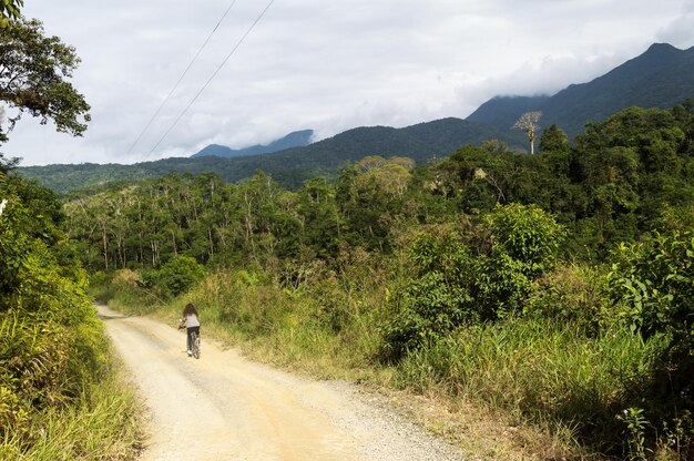 Woman riding a bicycle in the middle of nature