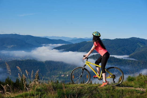 Woman riding on a bicycle in the mountains