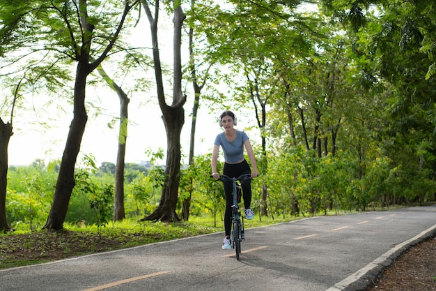 Woman riding a bicycle in the park Healthy lifestyle and sport concept