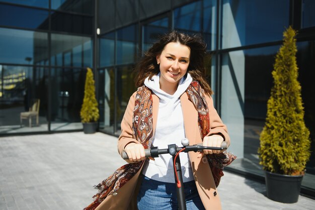 Woman riding an electric scooter outdoors