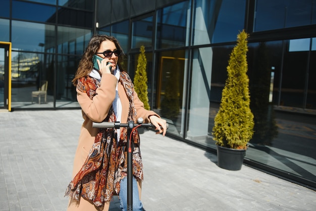 Woman riding an electric scooter outdoors