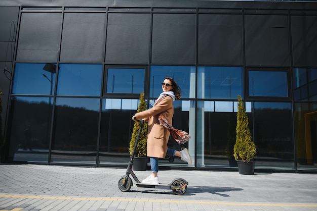 Woman riding an electric scooter outdoors