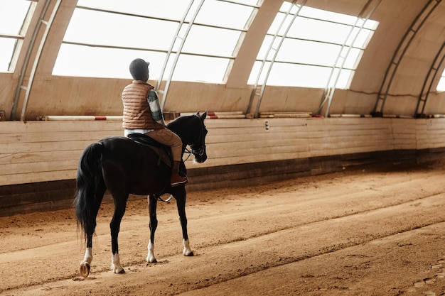 Woman Riding Horse Indoors