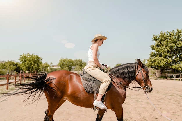 Woman riding a horse in a village