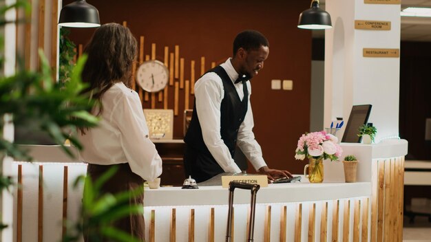 Woman ringing service bell at reception